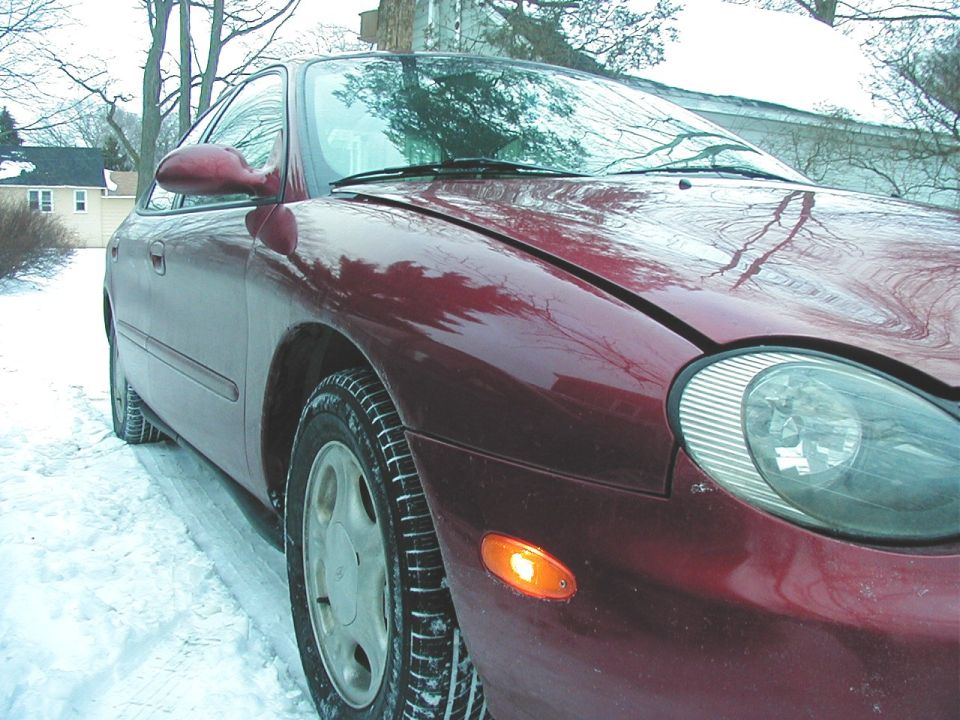 Red 1997 Ford Taurus 3q-front view in snow