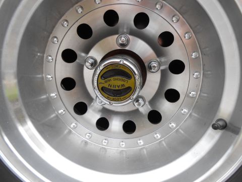 1992 Ford Bronco - A WARN locking hub is visible on the silver alloy wheel, indicating a four-wheel-drive system.