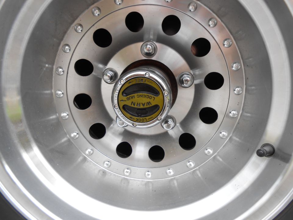 Close-up of a WARN locking hub on a silver alloy wheel