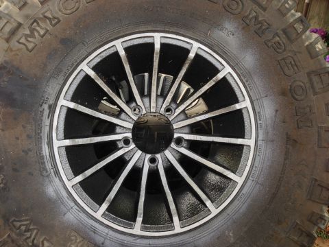 1979 Ford Bronco - A close-up view of a vehicle's wheel and tire, showing the tread and rim details.