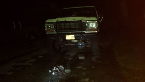Lifted 1979 Ford Bronco front view at night with yellow license plate 722 QTP.