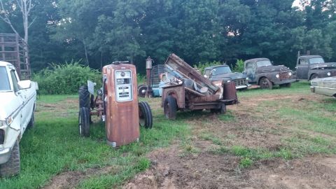 2015 Chevrolet new - A collection of vintage and rusted vehicles and a gas pump are parked in a grassy, outdoor lot with trees in the background. A white pickup…