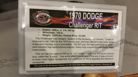 1991 Ford LTD Crown Victoria - Museum display placard describing a 1970 Dodge Challenger R/T, listing engine, wheelbase, weight, and price.