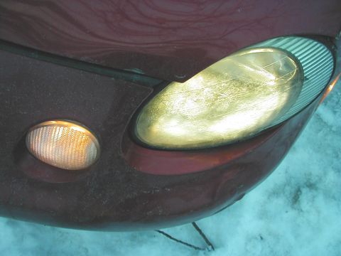 1997 Ford Taurus - The front corner of a car is visible, a headlight and an amber turn signal, with a watermark for Supermotors.net.
