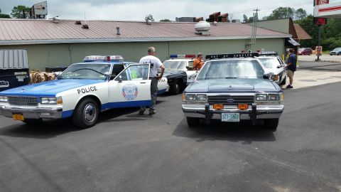 1991 Ford LTD Crown Victoria - Photograph of a gathering of vintage police cars, not a technical document.
