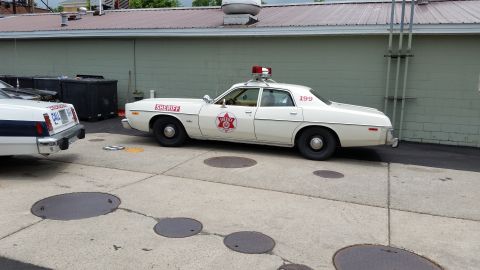1991 Ford LTD Crown Victoria - Photograph of a vintage Sheriff Dodge sedan, not a technical document.