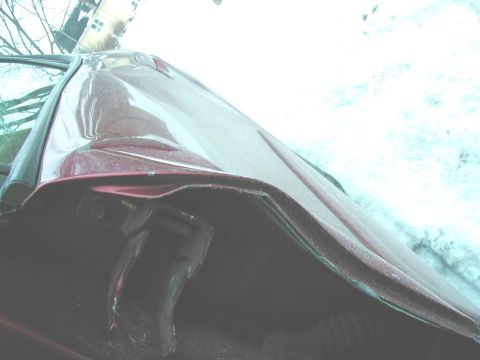 1997 Ford Taurus - Damage to the fender of a red car is visible in this close-up shot.