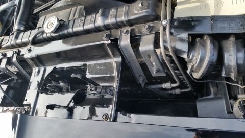 1991 Ford LTD Crown Victoria - Photograph of an engine bay inner fender area with radiator hose and horn, not a technical document.