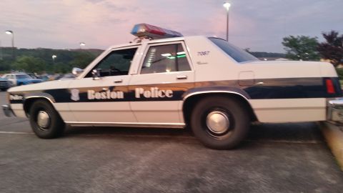 1991 Ford LTD Crown Victoria - Photograph of a Boston Police sedan cruiser parked at dusk, not a technical document.