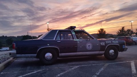 1991 Ford LTD Crown Victoria - Photograph of a State Police sedan cruiser at sunset, not a technical document.