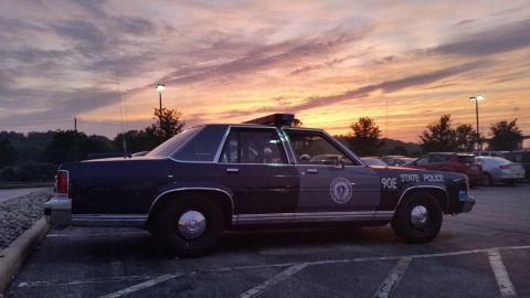 1991 Ford LTD Crown Victoria - Photograph of a State Police sedan cruiser at sunset, not a technical document.