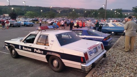 1991 Ford LTD Crown Victoria - Photograph of a Boston Police sedan cruiser at a car show at dusk, not a technical document.