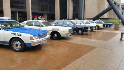 1991 Ford LTD Crown Victoria - Photo of vintage Police, Sheriff and State Police cars lined up on a plaza, not a technical document.