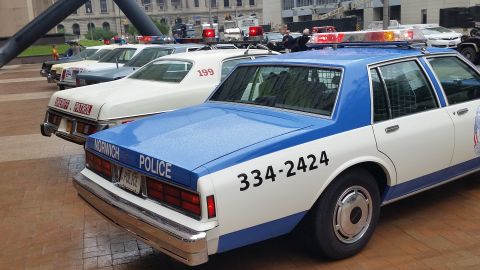 1991 Ford LTD Crown Victoria - Photo of a Norwich Police Caprice and lineup of vintage patrol cars, not a technical document.