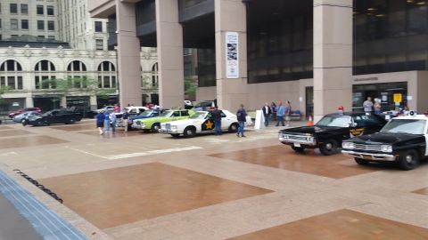 1991 Ford LTD Crown Victoria - Photograph of vintage police vehicles on display at an outdoor car show, not a technical document.