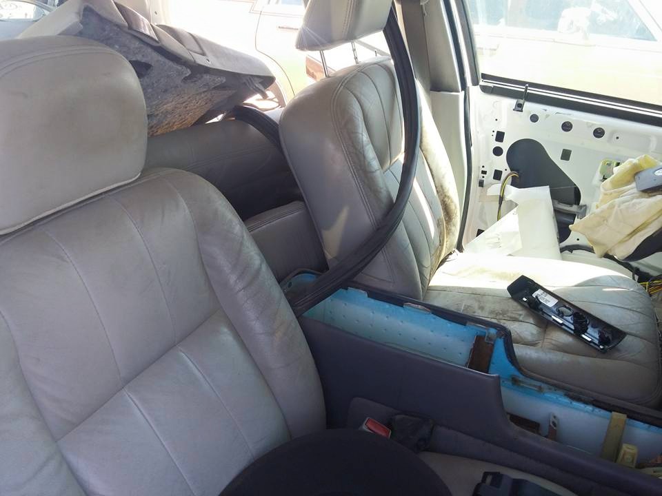 Stripped car interior with leather seats and exposed center console