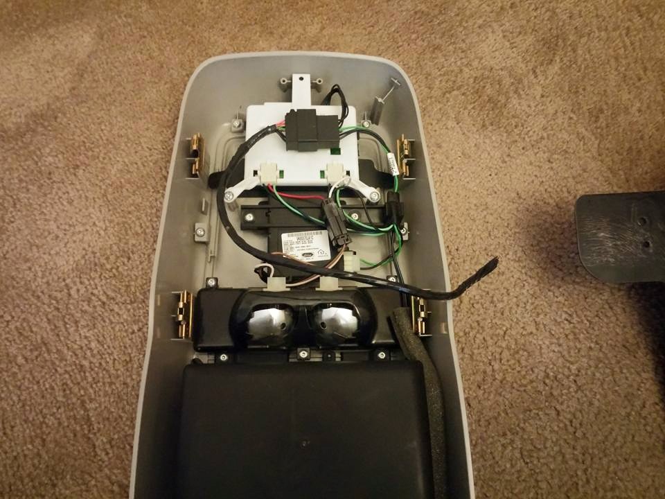 Underside of an overhead console showing wiring, lights and motor