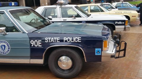 1991 Ford LTD Crown Victoria - Photograph of the front quarter of a Massachusetts State Police Ford cruiser, not a technical document.