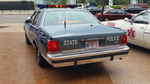 1991 Ford LTD Crown Victoria - Photograph of the rear of a blue State Police Ford cruiser, not a technical document.
