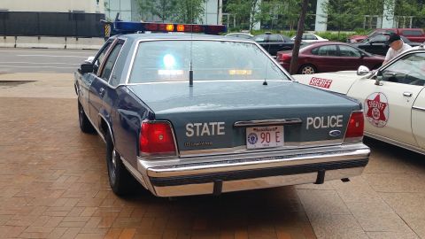 1991 Ford LTD Crown Victoria - Photograph of the rear of a blue State Police Ford cruiser, not a technical document.