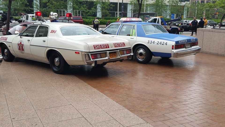 White Sheriff Patrol car and blue Toronto Police car parked together
