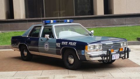 1991 Ford LTD Crown Victoria - Photograph of a Massachusetts State Police Ford cruiser, not a technical document.