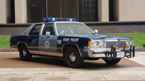 1991 Ford LTD Crown Victoria - Photograph of a Massachusetts State Police Ford cruiser, not a technical document.