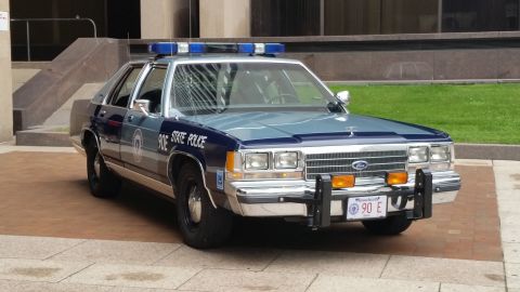 1991 Ford LTD Crown Victoria - Photograph of a Massachusetts State Police Ford cruiser, not a technical document.