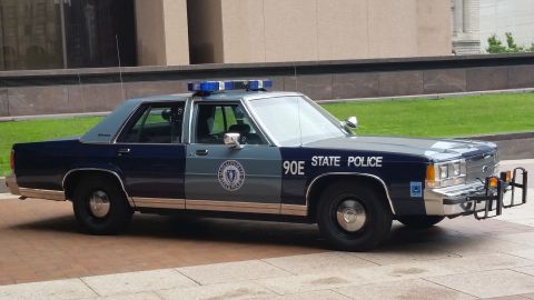 1991 Ford LTD Crown Victoria - Photograph of a Massachusetts State Police Ford cruiser in profile, not a technical document.