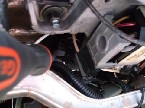 1999 Mercury Grand Marquis - A close-up view of wiring harnesses and electrical connectors under the dashboard of a vehicle, possibly during a repair or modification. A…