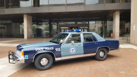 1991 Ford LTD Crown Victoria - Photograph of a Massachusetts State Police Ford cruiser, not a technical document.