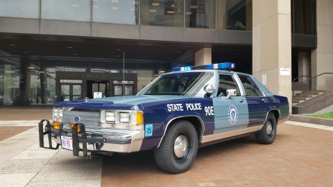 1991 Ford LTD Crown Victoria - Photo of a Massachusetts State Police Ford Crown Victoria cruiser, unit 90E, with front push bar.