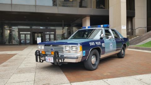 1991 Ford LTD Crown Victoria - Photo of a Massachusetts State Police Ford Crown Victoria cruiser, unit 90E, with light bar.