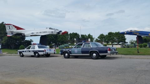 1991 Ford LTD Crown Victoria - Photo of Boston Police and Massachusetts State Police Crown Victoria cruisers near a U.S. Air Force display jet.