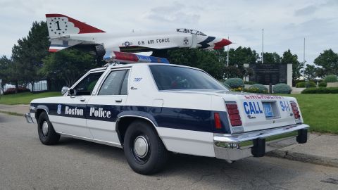 1991 Ford LTD Crown Victoria - Photo of a Boston Police Ford Crown Victoria cruiser, unit 7087, parked near a U.S. Air Force display jet.