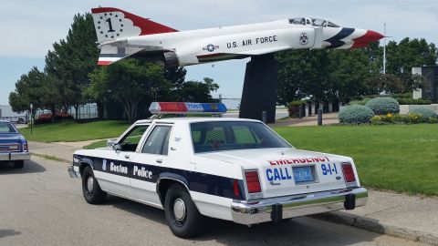 1991 Ford LTD Crown Victoria - Photo of a Boston Police Ford Crown Victoria cruiser parked near a U.S. Air Force display jet.