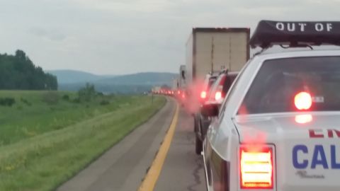 1991 Ford LTD Crown Victoria - Photograph of stopped highway traffic showing illuminated tail lights at dusk beside an emergency vehicle.