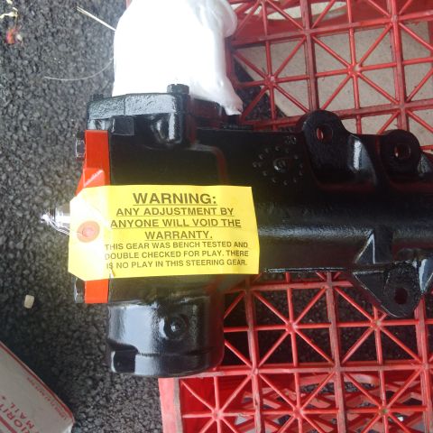 1978 Ford Bronco - A black steering gear assembly with a yellow warning tag is shown. The tag states that any adjustment will void the warranty and that the g…