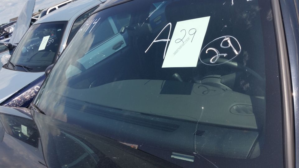 Car windshield with a handwritten A29 auction sign inside
