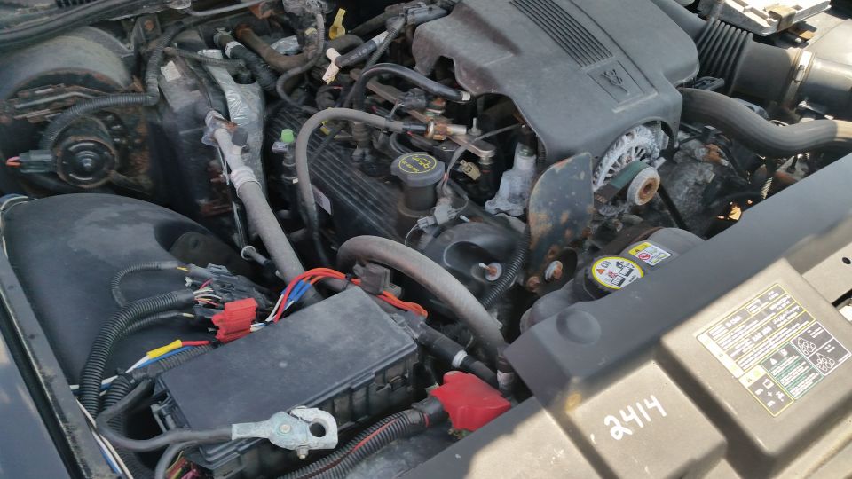 Engine bay with battery, wiring and intake of a Crown Victoria
