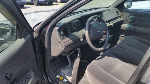 2001 Ford Crown Victoria - Photograph of a Crown Victoria interior with dashboard, steering wheel and cloth seats, not a technical document.