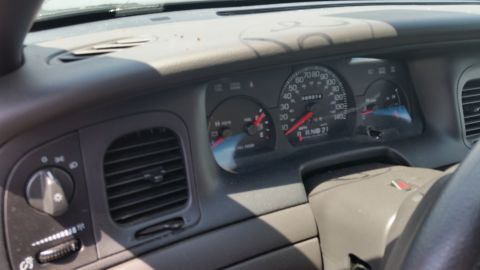 2001 Ford Crown Victoria - Photograph of a Ford Crown Victoria instrument cluster and dashboard, not a technical document.