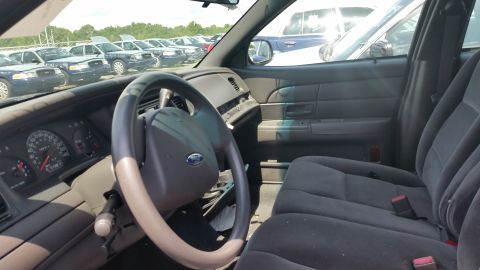 2001 Ford Crown Victoria - Photograph of the driver-side interior of a Crown Victoria viewed through the open door, not a technical document.