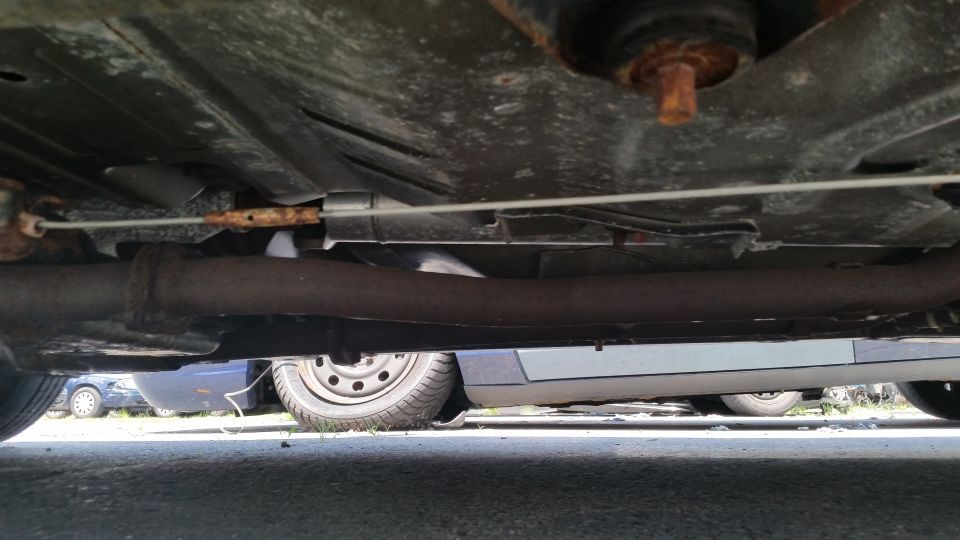 Undercarriage view of a sedan showing exhaust and frame