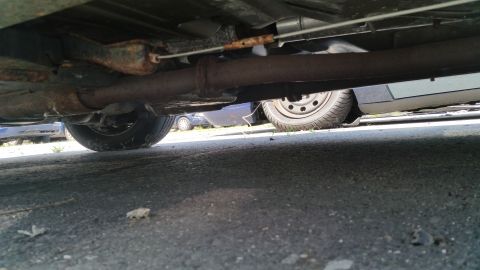 2001 Ford Crown Victoria - Photograph of a vehicle undercarriage with exhaust and suspension, not a technical document.