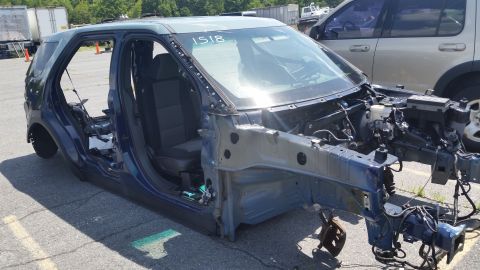 2001 Ford Crown Victoria - Photograph of a dismantled SUV body shell at a salvage yard, not a technical document.