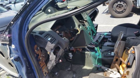 2001 Ford Crown Victoria - Photograph of a dismantled vehicle interior with exposed dash and wiring, not a technical document.