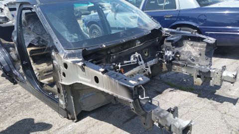 2001 Ford Crown Victoria - Photograph of a dismantled vehicle front structure at a salvage yard, not a technical document.