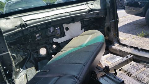 2001 Ford Crown Victoria - Photograph of a dismantled vehicle interior with bare firewall, not a technical document.