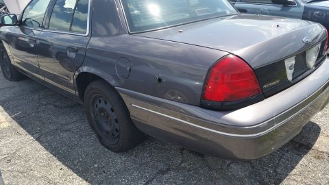 2001 Ford Crown Victoria - Photograph of the rear quarter of a gray Ford sedan, not a technical document.